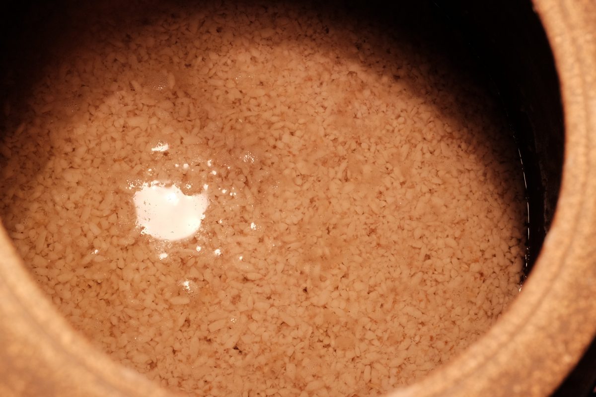 brew is finished fermenting as indicated by clear layer of liquid on top of rice