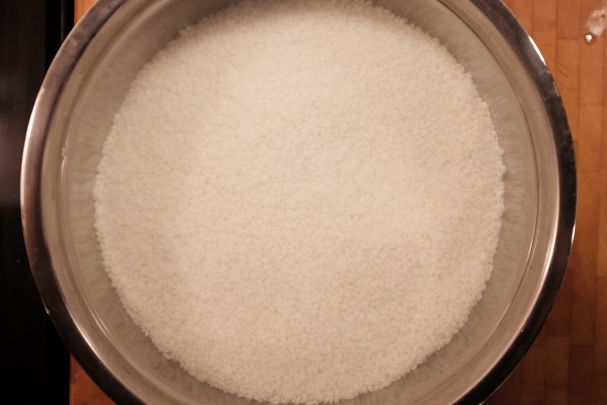 rice soaking for 3 hours in bowl of fresh water