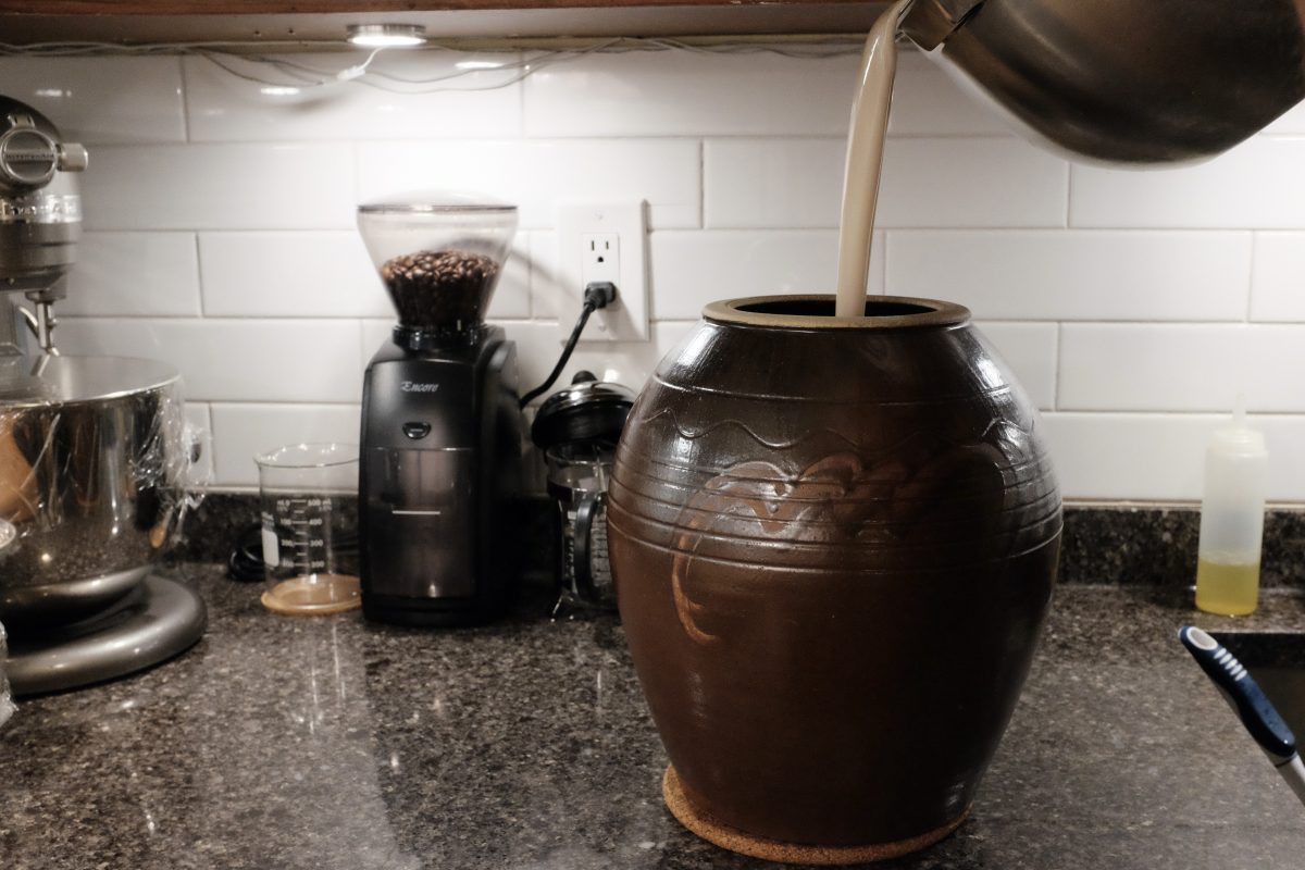 pouring mixture into onggi jar