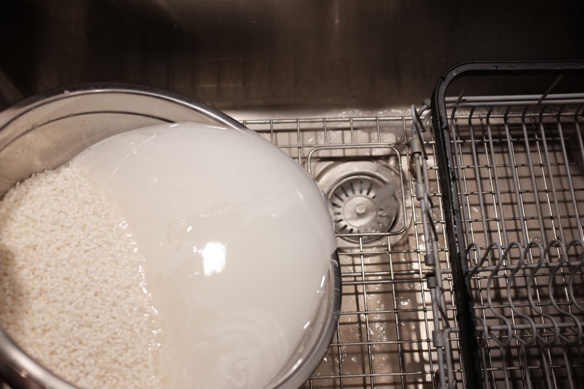 pouring off water while washing rice
