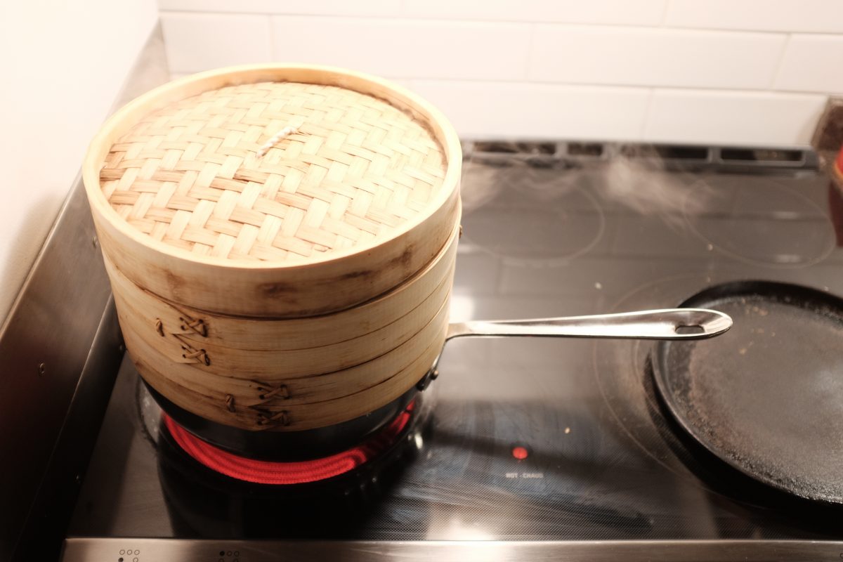 rice in steamer over pot of boiling water