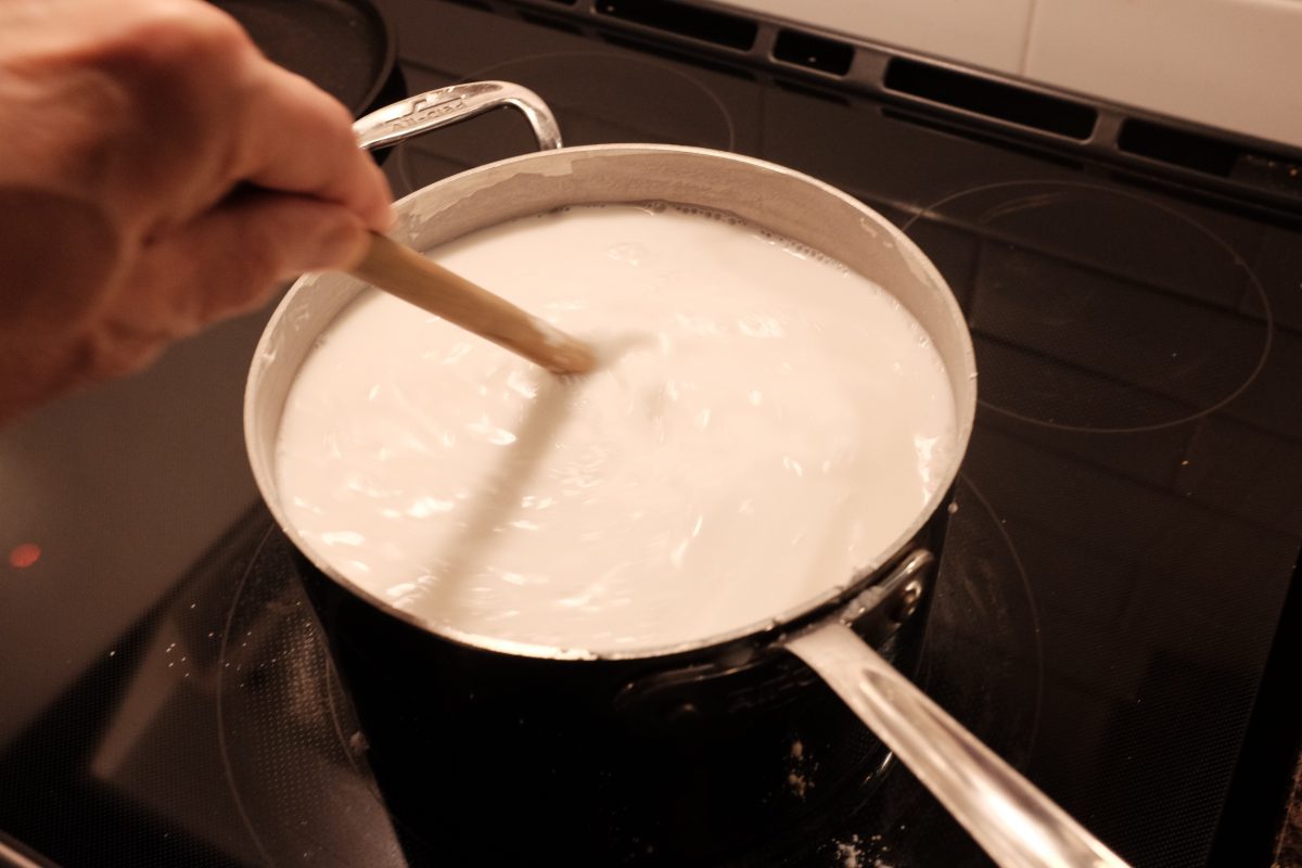 mixing rice flour and water in pot over medium high heat 