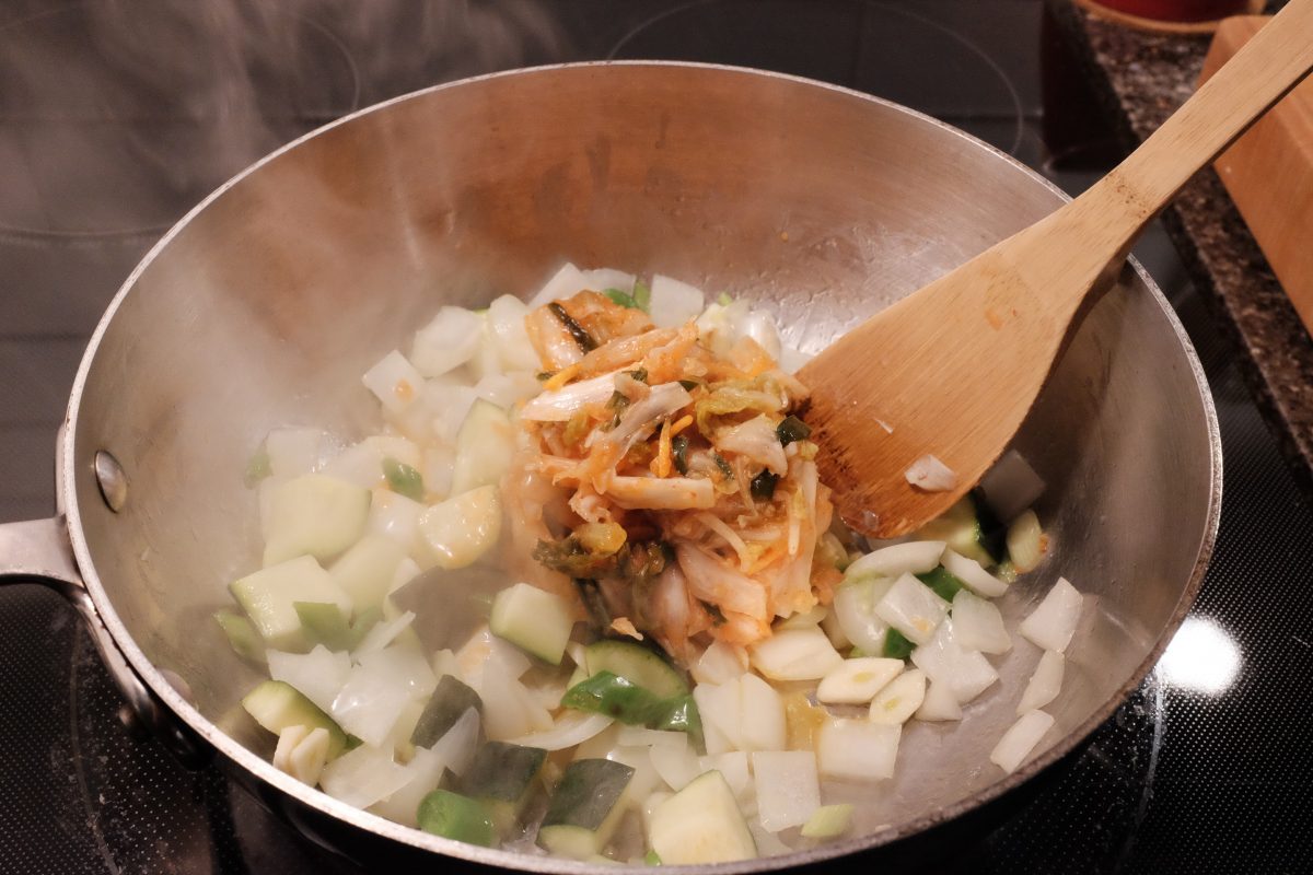 adding in sour kimchi