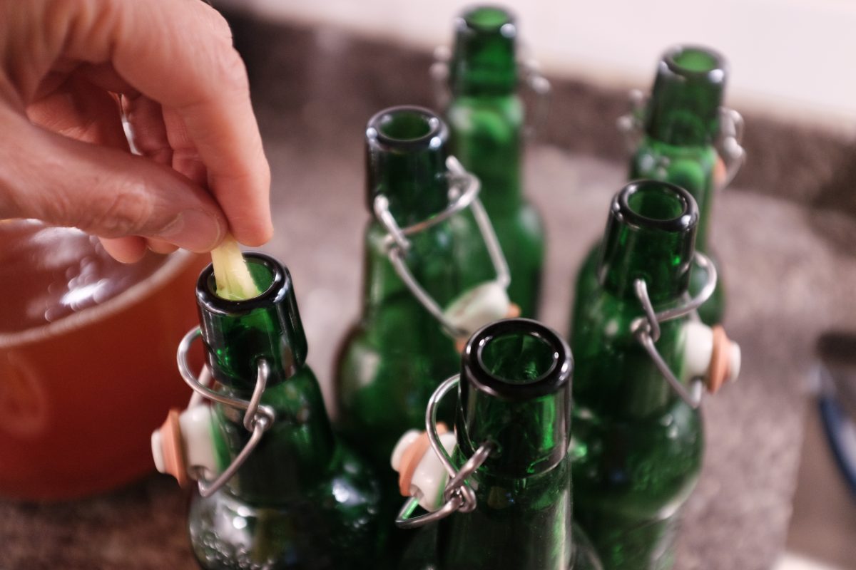 adding fresh ginger to bottles