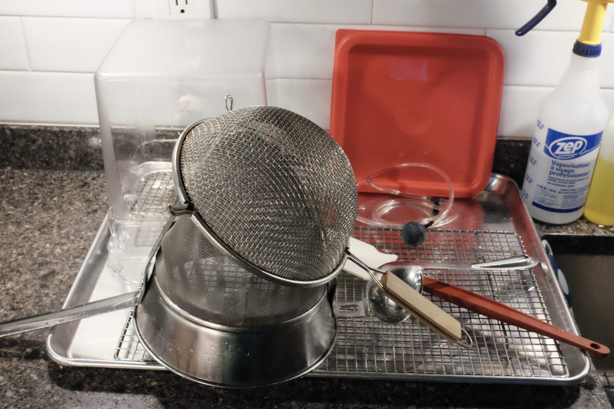 sanitized tools for straining pear vinegar mash