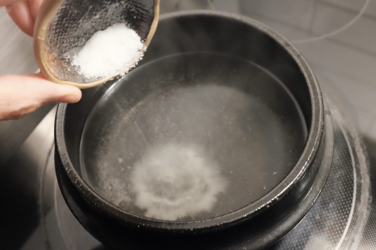 adding salt to boiling water