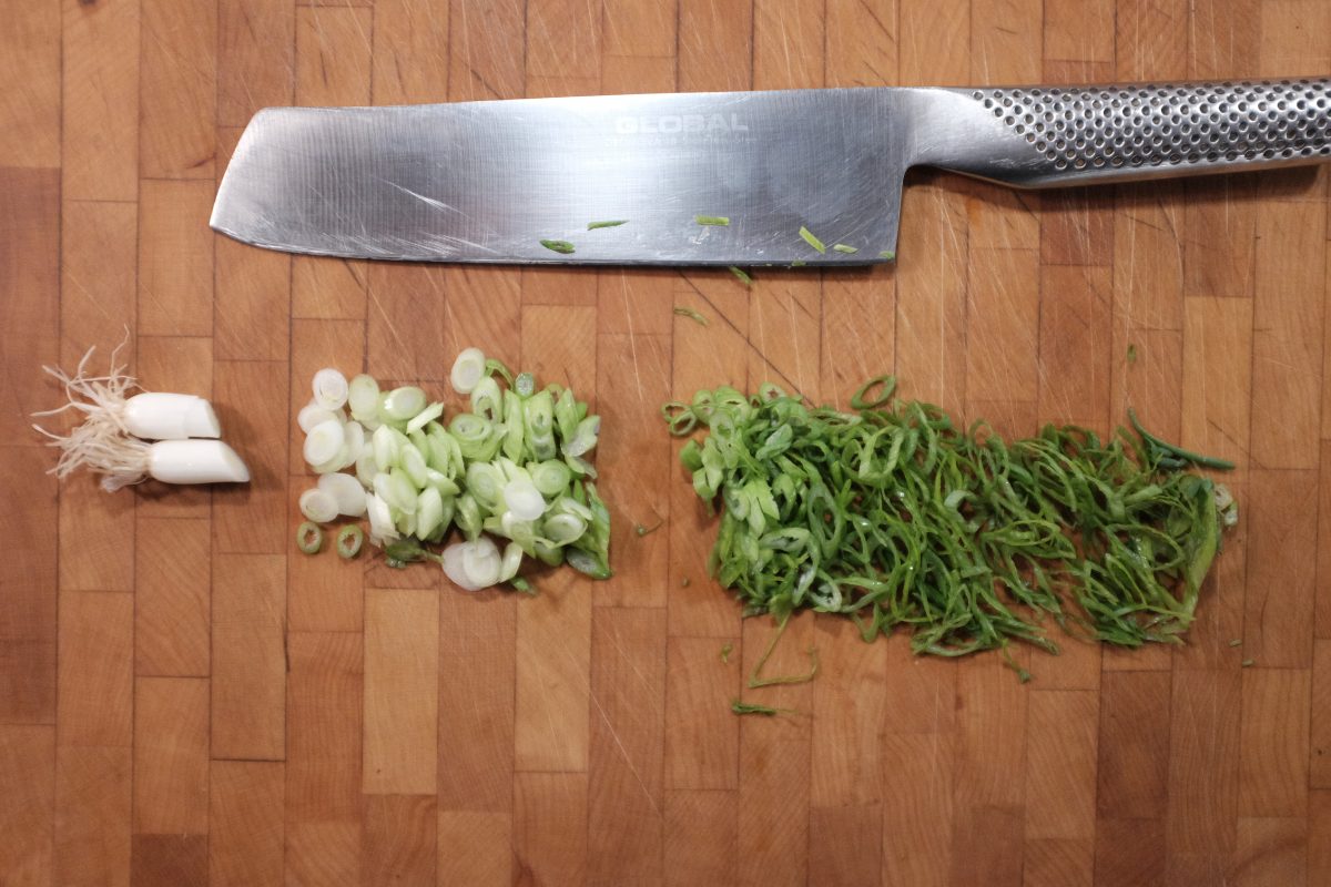 chopped green onion divided into roots, whites and greens