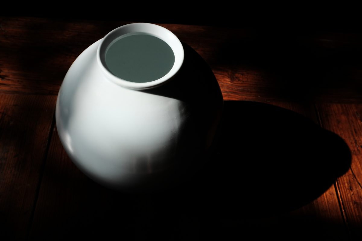 a moon jar from above lit by sun